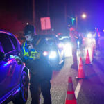 Officers check IDs at DUI Checkpoint